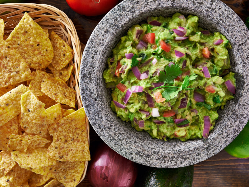mexican guacamole in molcajete with tortilla chips